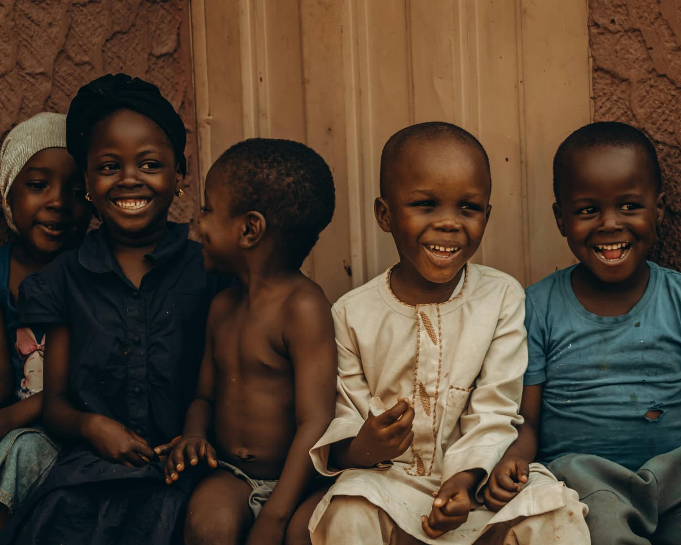 Group of children laughing together — warmth, safety, joy