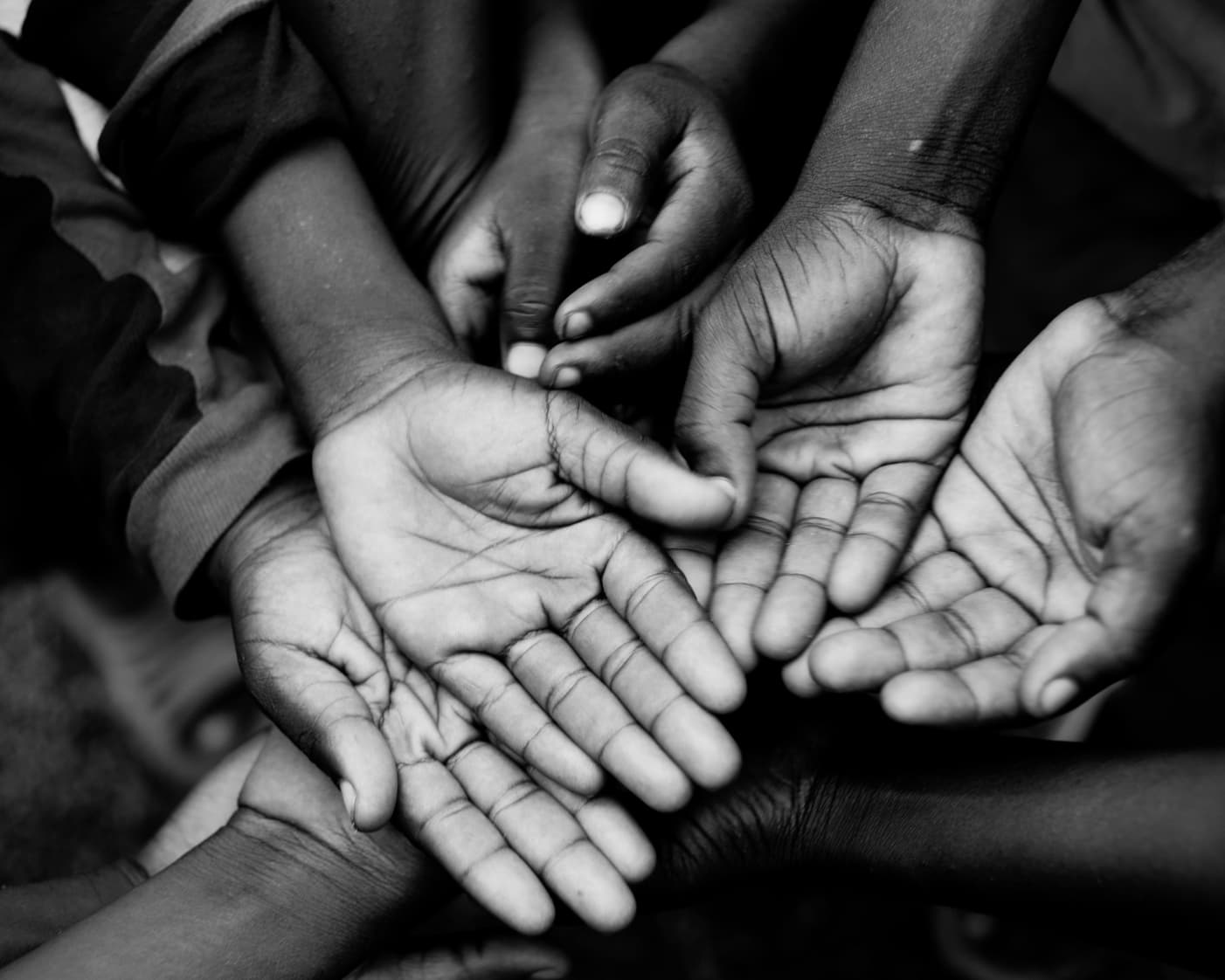 Children's open palms reaching upward — reaching for hope