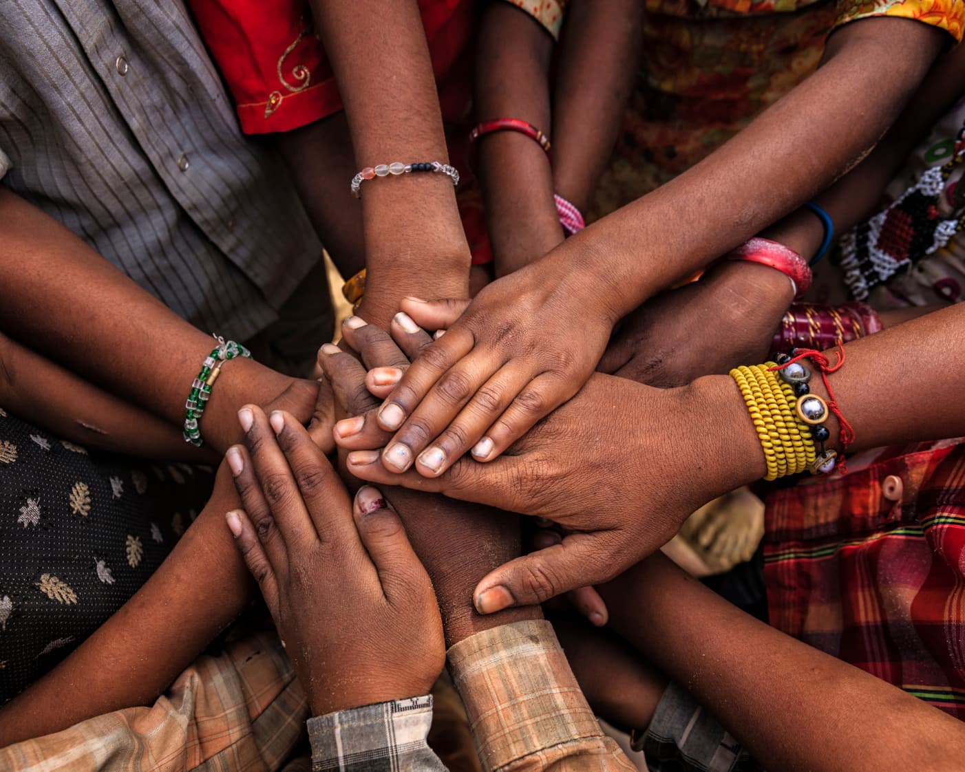 Many colourful hands joined — community and care
